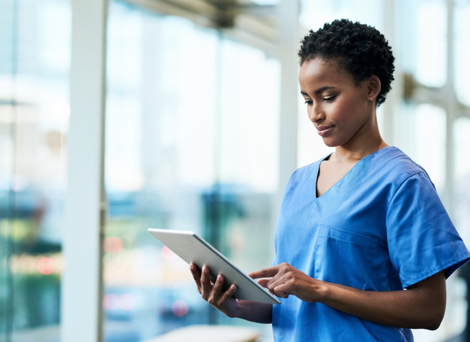 Female doctor looking down at tablet