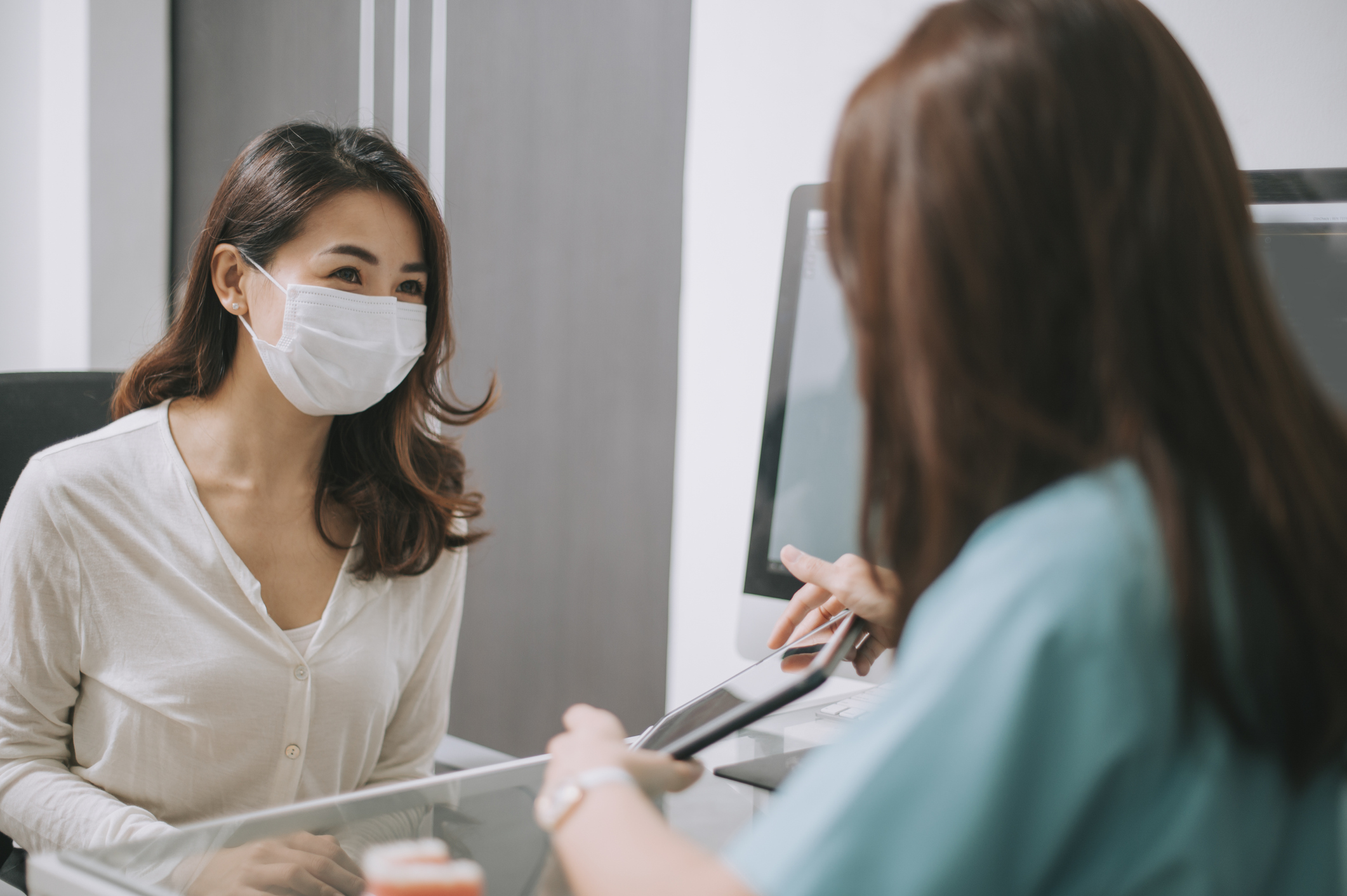 Female showing a medical expert something on a tablet